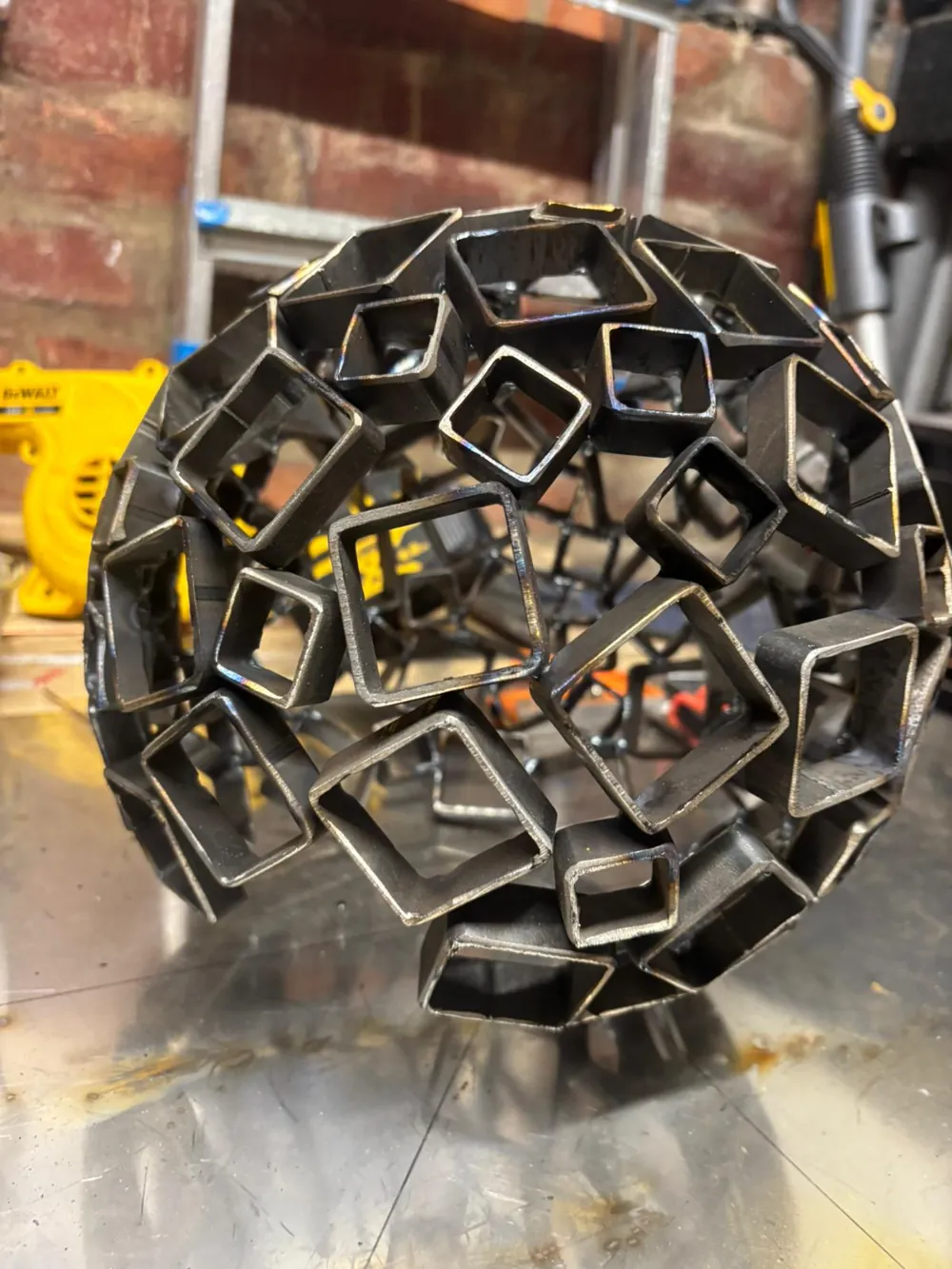 The lattice of welded steel squares up close.
